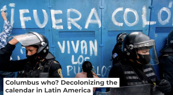 Demonstrators make graffiti reading ‘Columbus Out, Long Live the People’ on a fence protecting a statue of Christopher Columbus in Mexico City on Oct. 12, 2020. Pedro Pardo/AFP via Getty Images